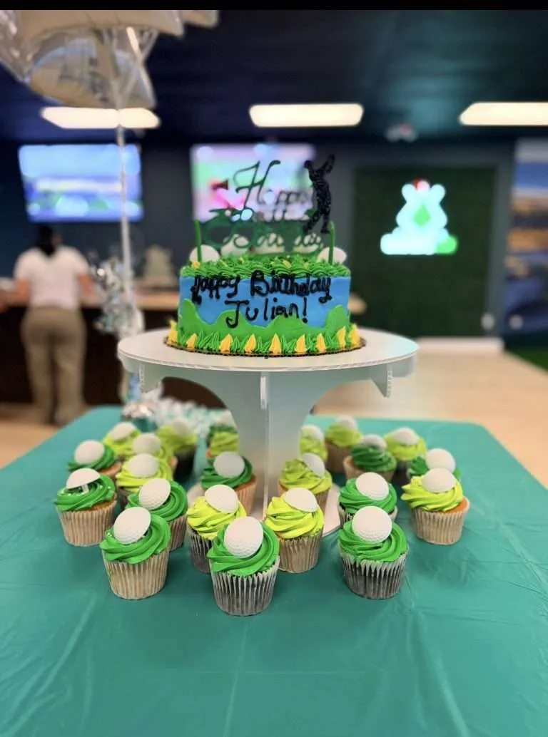 Birthday cake and golf-ball cupcakes at a Golfer's Den party